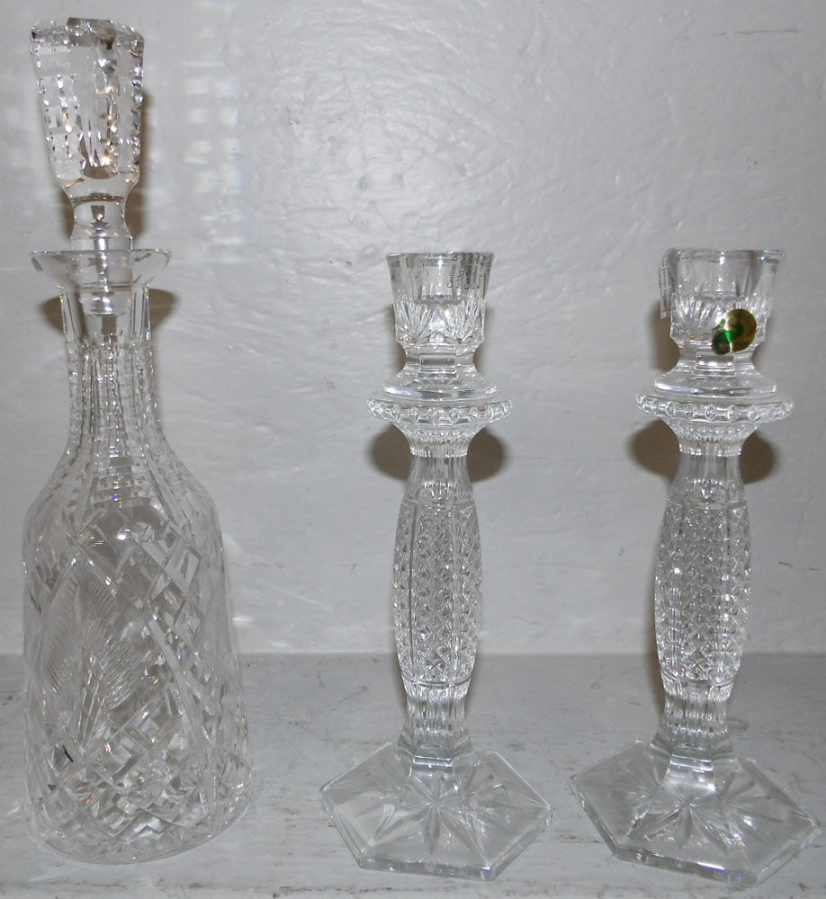 Pair of Waterford Crystal Candlesticks & Decanter: Pair of Waterford Crystal Candlesticks & Decanter. Up to 13 3/4" H 4" Dia. ALL DESCRIPTIONS AND ANY CONDITION STATEMENT GIVEN BY LANGSTON AUCTION GALLERY ARE STRICTLY OPINIONS AND LANGSTON'S SHALL HAV