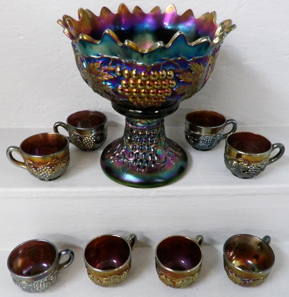 Antique Nine Piece Purple Carnival Glass Grape & Cable Punch Bowl & Cups Signed Northwood: Antique Nine Piece Purple Carnival Glass Grape & Cable Punch Bowl & Cups Signed Northwood. 11" H 11" Dia ALL DESCRIPTIONS AND ANY CONDITION STATEMENT GIVEN BY LANGSTON AUCTION GALLERY ARE STRICTLY OPI