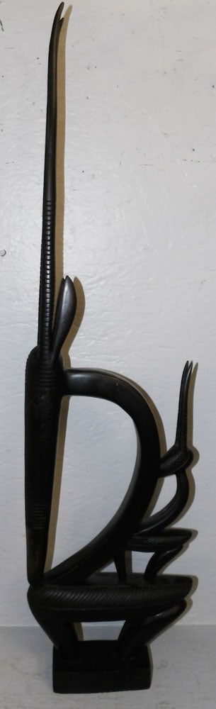 Wood Carved African Antelope: Wood Carved African Antelope . 36" h 10" W 2 3/4" D ALL DESCRIPTIONS AND ANY CONDITION STATEMENT GIVEN BY LANGSTON AUCTION GALLERY ARE STRICTLY OPINIONS AND LANGSTON'S SHALL HAVE NO RESPONSIBILITY FOR