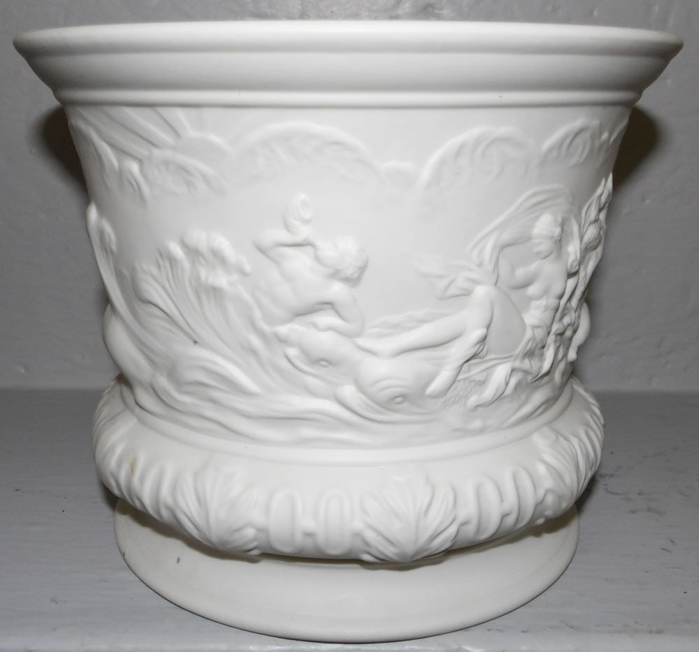 Parian Style Neoclassical Motif Jardiniere: Parian Style Neoclassical Motif Jardiniere . 7 1/4" H 9" Dia. ALL DESCRIPTIONS AND ANY CONDITION STATEMENT GIVEN BY LANGSTON AUCTION GALLERY ARE STRICTLY OPINIONS AND LANGSTON'S SHALL HAVE NO RESPONSI