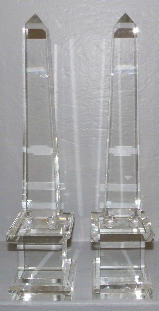 Pair of Crystal Obelisks, One Has Large Chip: Pair of Crystal Obelisks, One Has Large Chip. 19 1/4" H 4 1/4" Dia. ALL DESCRIPTIONS AND ANY CONDITION STATEMENT GIVEN BY LANGSTON AUCTION GALLERY ARE STRICTLY OPINIONS AND LANGSTON'S SHALL HAVE NO RE