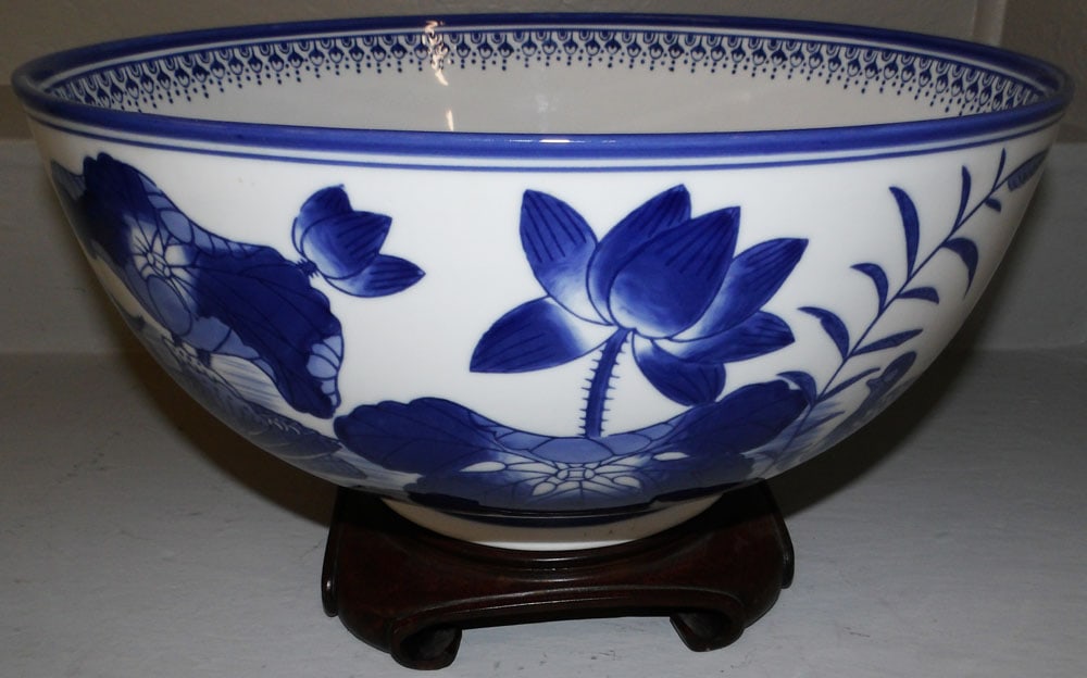 Large Oriental Blue & White Porcelain Bowl with Pheasant Motif on Teak Wood Stand: Large Oriental Blue & White Porcelain Bowl with Pheasant Motif on Teak Wood Stand . 9" H 15 3/4" Dia. ALL DESCRIPTIONS AND ANY CONDITION STATEMENT GIVEN BY LANGSTON AUCTION GALLERY ARE STRICTLY OPINIO