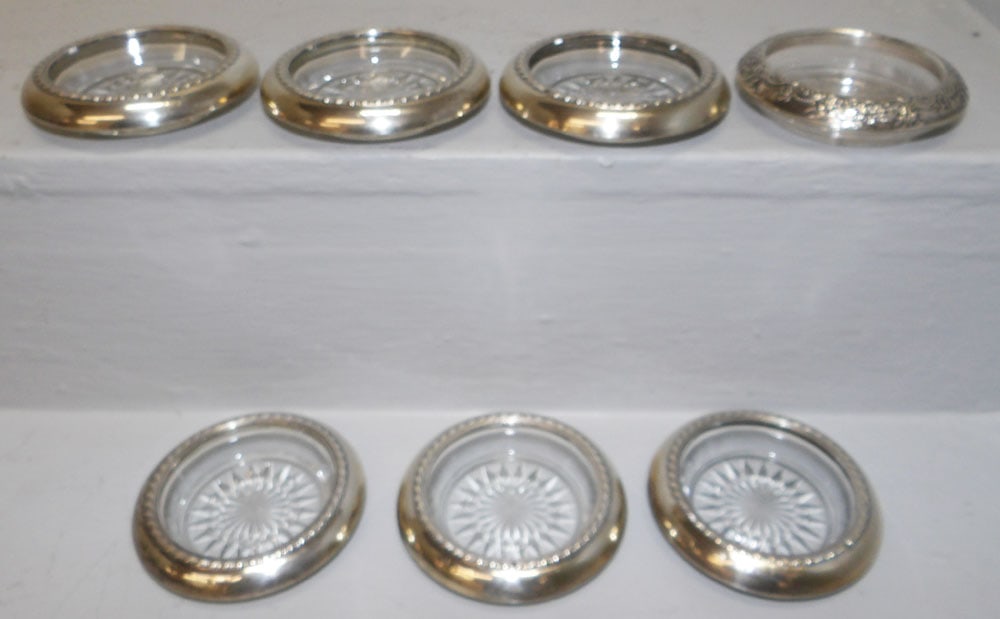 Lot Seven Glass Sterling Rimmed Coasters: Lot Seven Glass Sterling Rimmed Coasters. 4" Dia ALL DESCRIPTIONS AND ANY CONDITION STATEMENT GIVEN BY LANGSTON AUCTION GALLERY ARE STRICTLY OPINIONS AND LANGSTON'S SHALL HAVE NO RESPONSIBILITY FOR ER