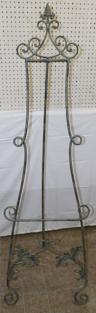 Wrought Iron Easel: Wrought Iron Easel. 65 1/2" H 17" W ALL DESCRIPTIONS AND ANY CONDITION STATEMENT GIVEN BY LANGSTON AUCTION GALLERY ARE STRICTLY OPINIONS AND LANGSTON'S SHALL HAVE NO RESPONSIBILITY FOR ERRORS OR OMISS