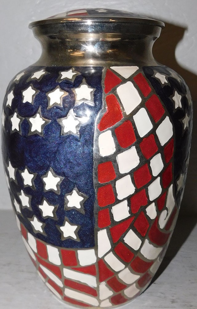Metal American Flag Ceremonial Burial Urn: Metal American Flag Ceremonial Burial Urn. 10" H 6 1/2" Dia ALL DESCRIPTIONS AND ANY CONDITION STATEMENT GIVEN BY LANGSTON AUCTION GALLERY ARE STRICTLY OPINIONS AND LANGSTON'S SHALL HAVE NO RESPONSIBI