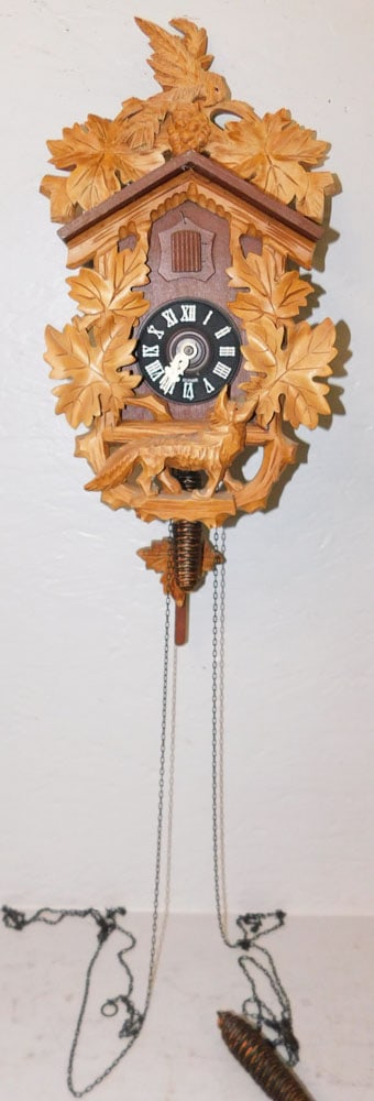 Cuckoo Clock: Cuckoo Clock. 12" H 8 1/4" W 5 1/4" D ALL DESCRIPTIONS AND ANY CONDITION STATEMENT GIVEN BY LANGSTON AUCTION GALLERY ARE STRICTLY OPINIONS AND LANGSTON'S SHALL HAVE NO RESPONSIBILITY FOR ERRORS OR OMI