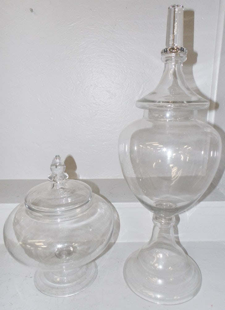Two Glass Covered Urns: Two Glass Covered Urns. 27" H 9 1/2" Dia ALL DESCRIPTIONS AND ANY CONDITION STATEMENT GIVEN BY LANGSTON AUCTION GALLERY ARE STRICTLY OPINIONS AND LANGSTON'S SHALL HAVE NO RESPONSIBILITY FOR ERRORS OR