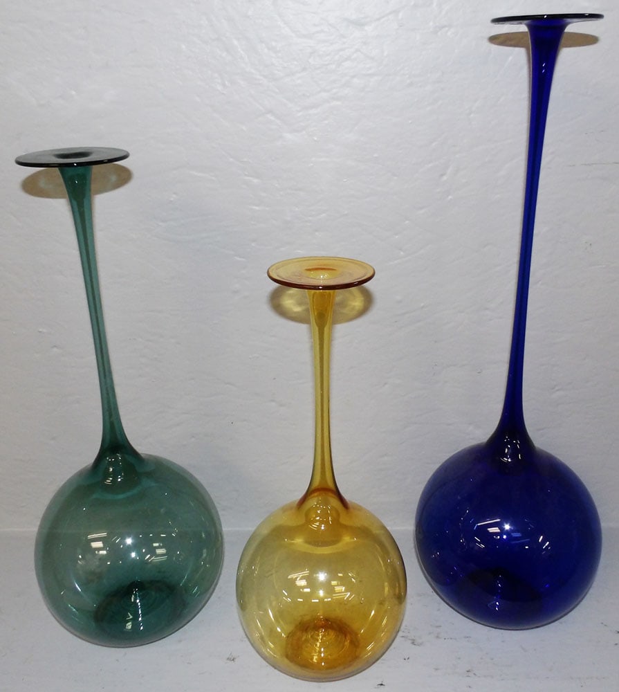 Three Graduated Colored Glass Candlesticks: Three Graduated Colored Glass Candlesticks. 19" H 5 1/2" Dia ALL DESCRIPTIONS AND ANY CONDITION STATEMENT GIVEN BY LANGSTON AUCTION GALLERY ARE STRICTLY OPINIONS AND LANGSTON'S SHALL HAVE NO RESPONSIB