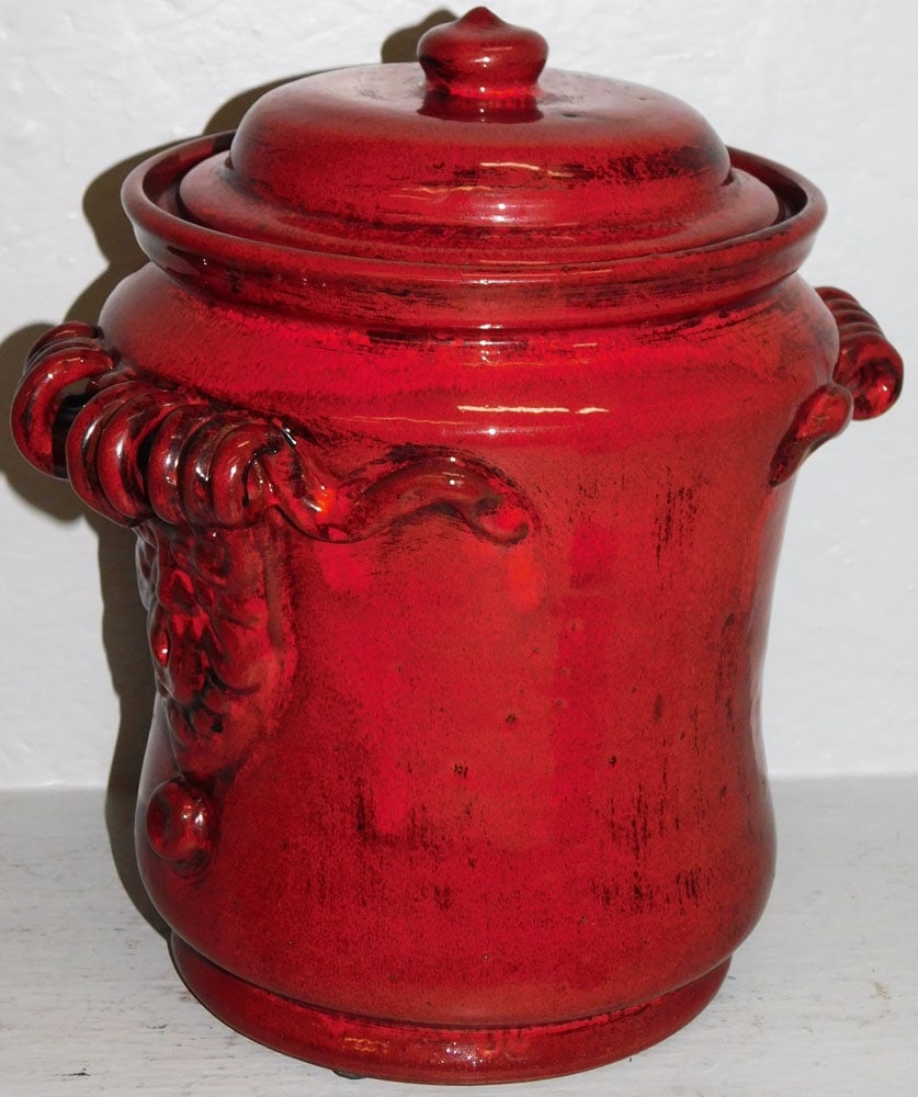 French Ceramic Bull's Blood Red Glaze Covered Urn with Molded Face Handles: French Ceramic Bull's Blood Red Glaze Covered Urn with Molded Face Handles. 12 1/2" H 11 1/2" Dia. ALL DESCRIPTIONS AND ANY CONDITION STATEMENT GIVEN BY LANGSTON AUCTION GALLERY ARE STRICTLY OPINIONS