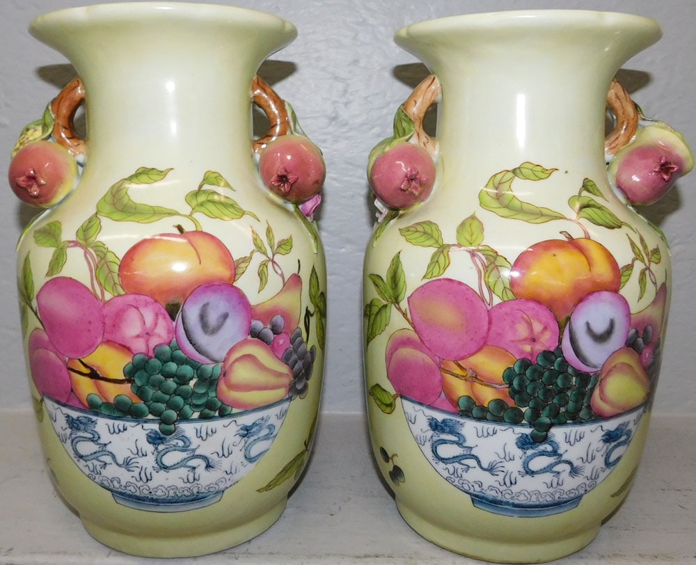 Pair of Oriental Painted Porcelain Urns with Pomegranate Handles : Pair of Oriental Painted Porcelain Urns with Pomegranate Handles . 12 1/2" H 8 1/4" W ALL DESCRIPTIONS AND ANY CONDITION STATEMENT GIVEN BY LANGSTON AUCTION GALLERY ARE STRICTLY OPINIONS AND LANGSTON'