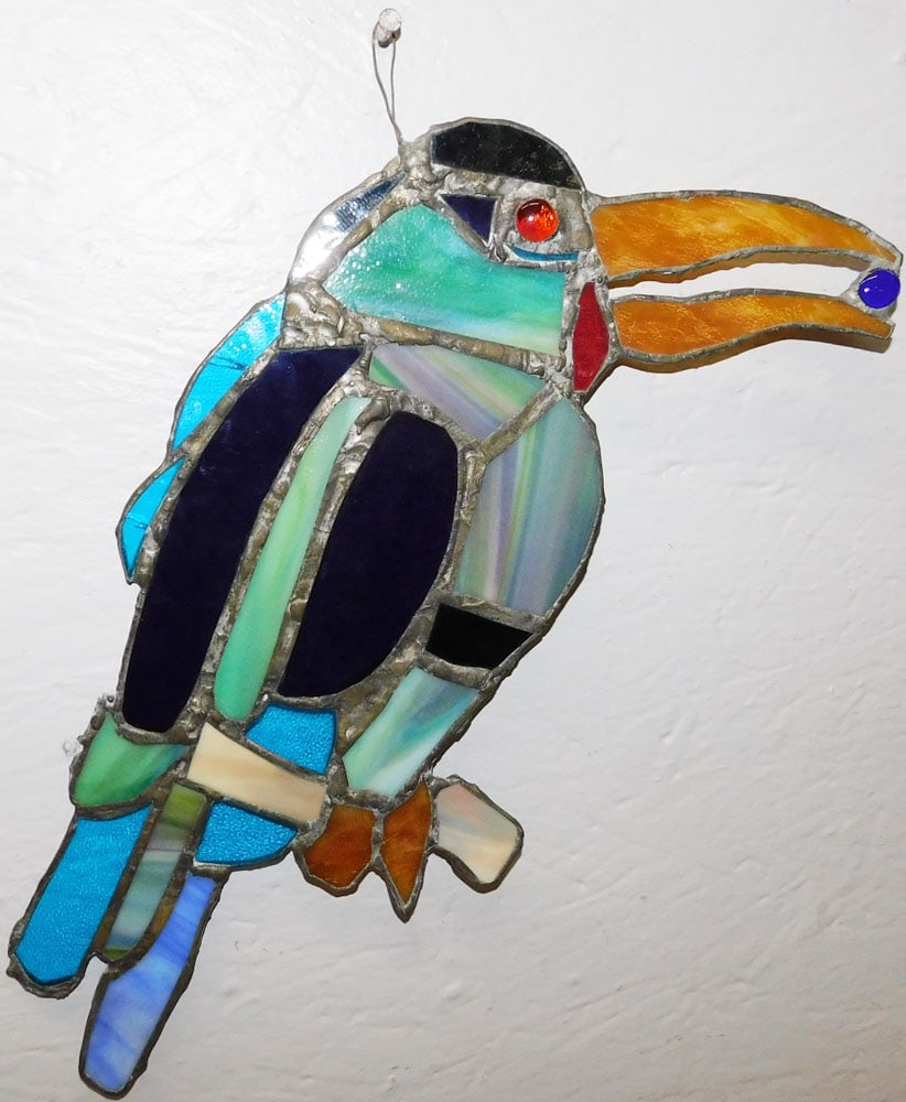 Antique Leaded Stained Glass Toucan Sun Catcher : Antique Leaded Stained Glass Toucan Sun Catcher . 17" L 9 1/4" W ALL DESCRIPTIONS AND ANY CONDITION STATEMENT GIVEN BY LANGSTON AUCTION GALLERY ARE STRICTLY OPINIONS AND LANGSTON'S SHALL HAVE NO RESPO