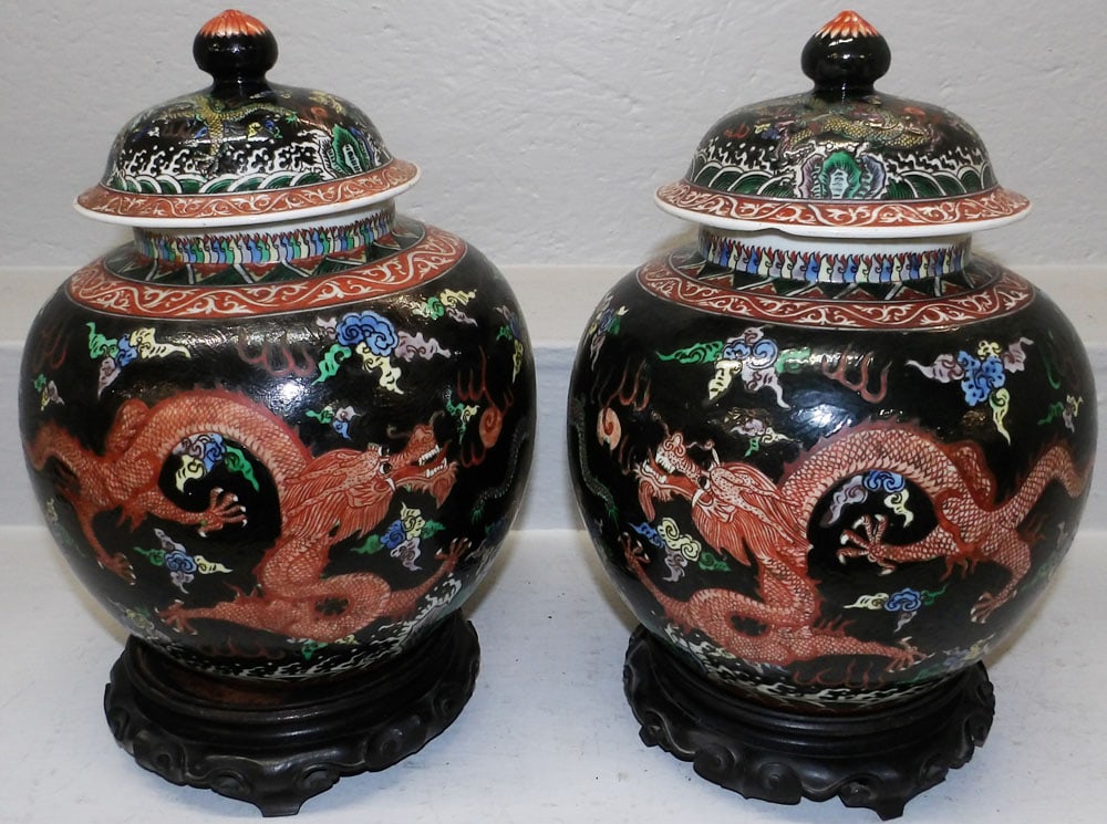 Pair of Antique Oriental Painted Porcelain Covered Urns on Teak Wood Stands: Pair of Antique Oriental Painted Porcelain Covered Urns on Teak Wood Stands. 15" H 10" Dia. ALL DESCRIPTIONS AND ANY CONDITION STATEMENT GIVEN BY LANGSTON AUCTION GALLERY ARE STRICTLY OPINIONS AND LAN