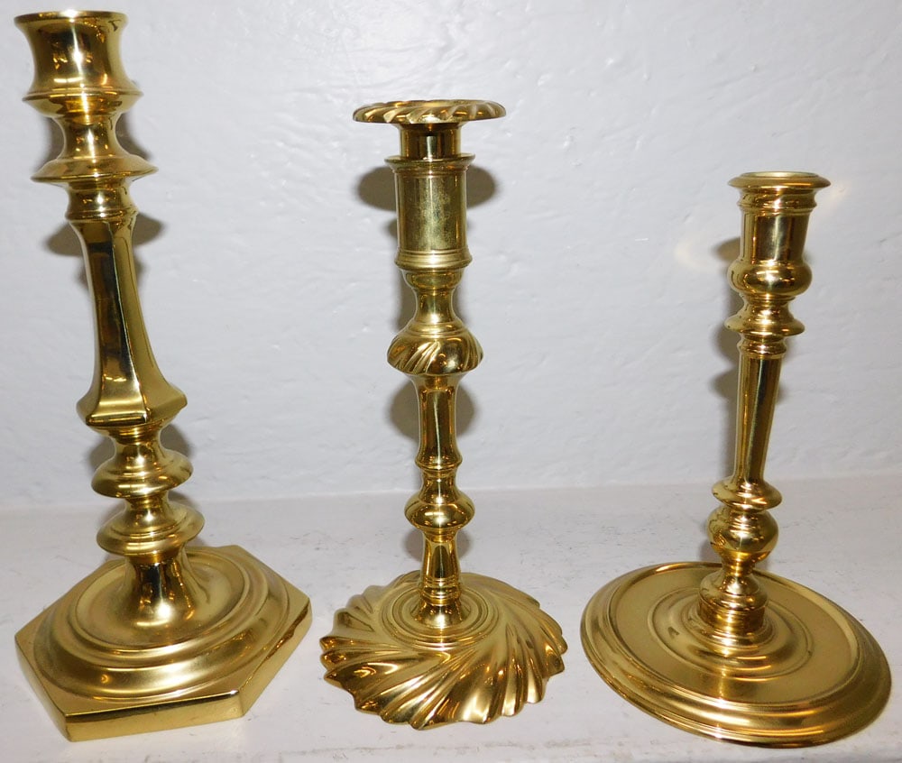 Three Brass Candlesticks By Virginia Metalcrafters: Three Brass Candlesticks By Virginia Metalcrafters. 10 3/4" H 4 3/4" Dia. ALL DESCRIPTIONS AND ANY CONDITION STATEMENT GIVEN BY LANGSTON AUCTION GALLERY ARE STRICTLY OPINIONS AND LANGSTON'S SHALL HAVE