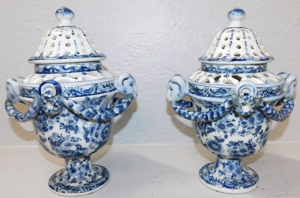 Pair of Blue & White Porcelain Pierced Covered Urns with Ram's Heads : Pair of Blue & White Porcelain Pierced Covered Urns with Ram's Heads . 11" H 8" W ALL DESCRIPTIONS AND ANY CONDITION STATEMENT GIVEN BY LANGSTON AUCTION GALLERY ARE STRICTLY OPINIONS AND LANGSTON'S SH