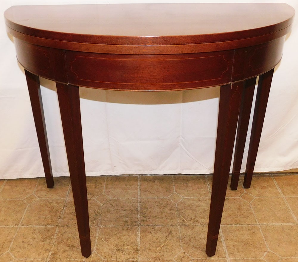 Mahogany Inlaid Fold Over Top Demi Lune Game Table: Mahogany Inlaid Fold Over Top Demi Lune Game Table. 30 1/4" H 36" W 18" D ALL DESCRIPTIONS AND ANY CONDITION STATEMENT GIVEN BY LANGSTON AUCTION GALLERY ARE STRICTLY OPINIONS AND LANGSTON'S SHALL HAVE