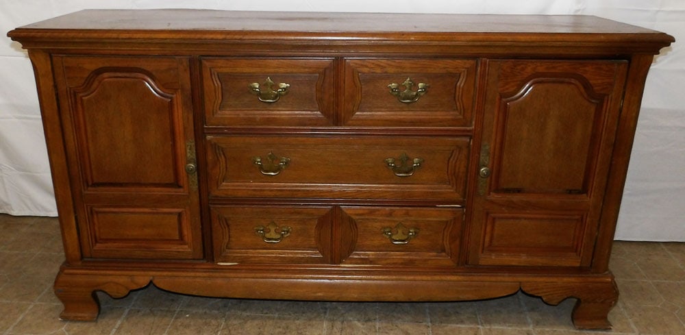 Oak Sideboard by Bassett: Oak Sideboard by Bassett . 33 1/2" H 64" W 18 1/4" D "ALL DESCRIPTIONS AND ANY CONDITION STATEMENT GIVEN BY LANGSTON AUCTION GALLERY ARE STRICTLY OPINIONS AND LANGSTON'S SHALL HAVE NO RESPONSIBILITY F