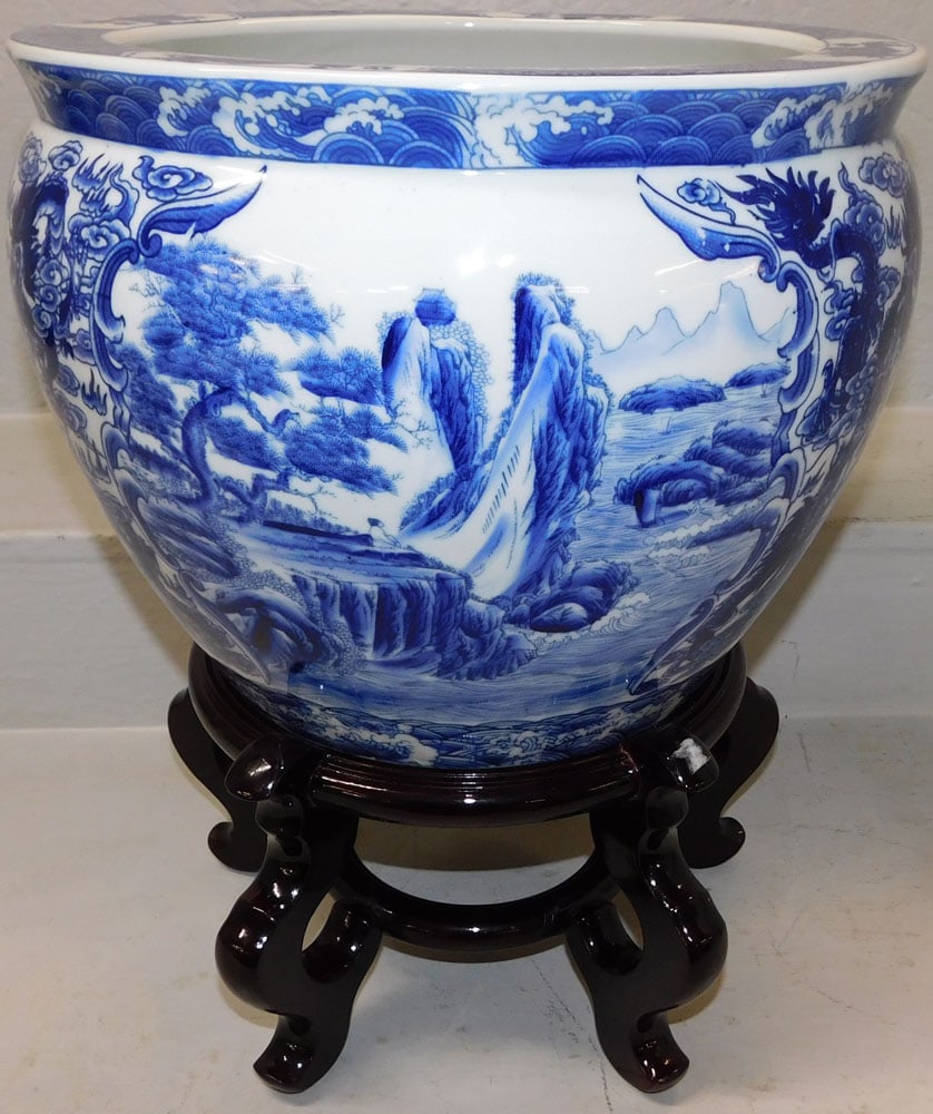 Oriental Blue & White Porcelain Jardiniere on Teak Wood Stand: Oriental Blue & White Porcelain Jardiniere on Teak Wood Stand. 18 1/2" H 15" Dia. ALL DESCRIPTIONS AND ANY CONDITION STATEMENT GIVEN BY LANGSTON AUCTION GALLERY ARE STRICTLY OPINIONS AND LANGSTON'S