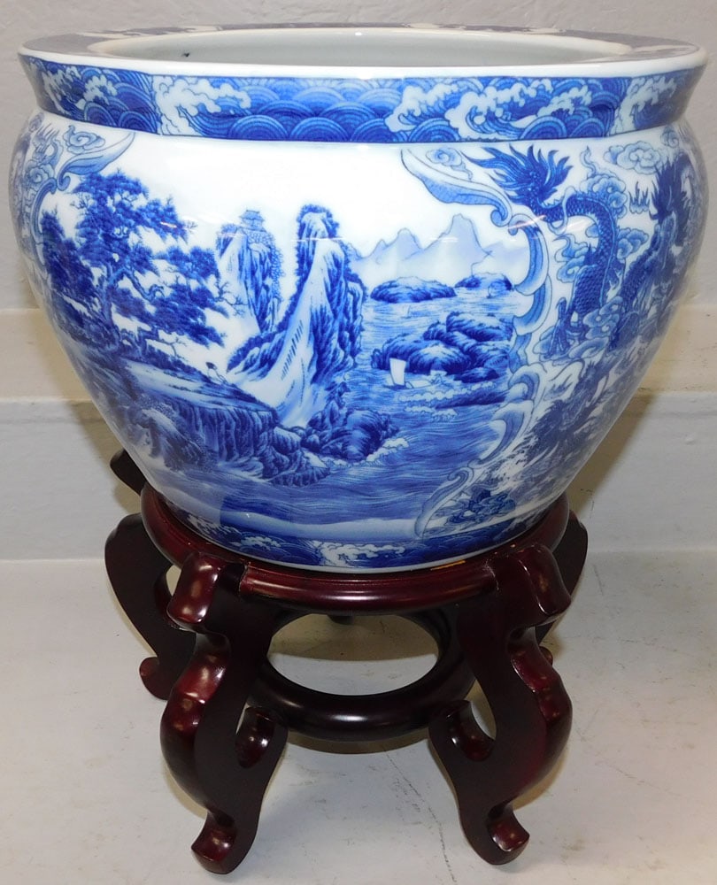 Oriental Blue & White Porcelain Jardiniere on Teak Wood Stand: Oriental Blue & White Porcelain Jardiniere on Teak Wood Stand . 17" H 13" Dia. ALL DESCRIPTIONS AND ANY CONDITION STATEMENT GIVEN BY LANGSTON AUCTION GALLERY ARE STRICTLY OPINIONS AND LANGSTON'S