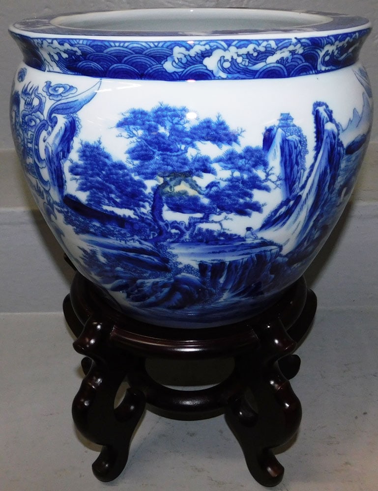 Oriental Blue & White Porcelain Jardiniere on Teak Wood Stand: Oriental Blue & White Porcelain Jardiniere on Teak Wood Stand. 14 3/4" H 10 1/2" Dia. ALL DESCRIPTIONS AND ANY CONDITION STATEMENT GIVEN BY LANGSTON AUCTION GALLERY ARE STRICTLY OPINIONS AND