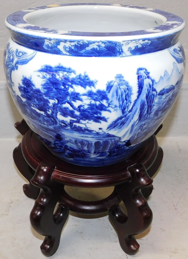 Oriental Blue & White Porcelain Jardiniere on Teak Wood Stand: Oriental Blue & White Porcelain Jardiniere on Teak Wood Stand . 13 1/4" H 9" Dia. ALL DESCRIPTIONS AND ANY CONDITION STATEMENT GIVEN BY LANGSTON AUCTION GALLERY ARE STRICTLY OPINIONS AND LANGSTON'S