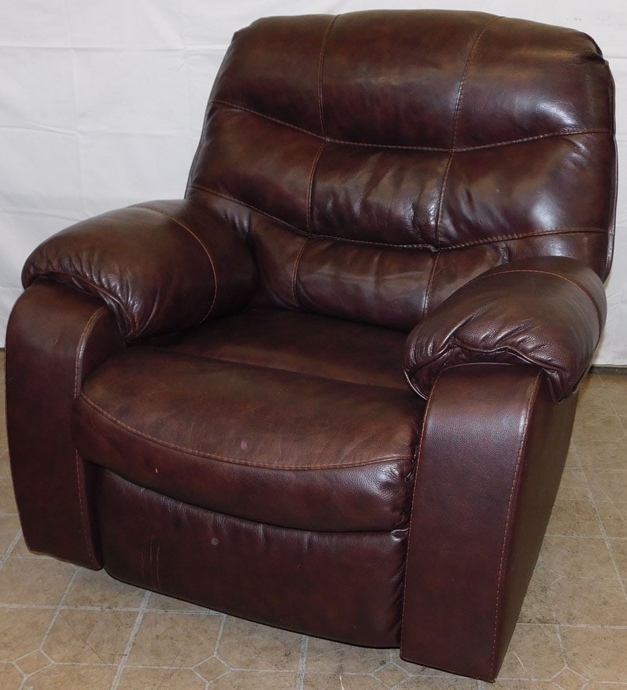 Leather Recliner by Ashley Furniture: Leather Recliner by Ashley Furniture. 39 1/2" H 39 1/2" W 36" D ALL DESCRIPTIONS AND ANY CONDITION STATEMENT GIVEN BY LANGSTON AUCTION GALLERY ARE STRICTLY OPINIONS AND LANGSTON'S SHALL HAVE NO