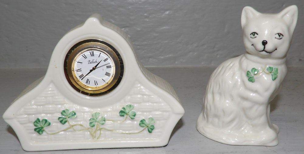 Irish Beleek Porcelain Cat & Clock: Irish Beleek Porcelain Cat & Clock. 3 3/4" H 5" W 2" D ALL DESCRIPTIONS AND ANY CONDITION STATEMENT GIVEN BY LANGSTON AUCTION GALLERY ARE STRICTLY OPINIONS AND LANGSTON'S SHALL HAVE NO