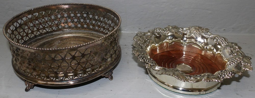 Two Silverplated Wine Coasters: Two Silverplated Wine Coasters. Up to 3 1/4" H 7" Dia. ALL DESCRIPTIONS AND ANY CONDITION STATEMENT GIVEN BY LANGSTON AUCTION GALLERY ARE STRICTLY OPINIONS AND LANGSTON'S SHALL HAVE NO RESPONSIBILITY