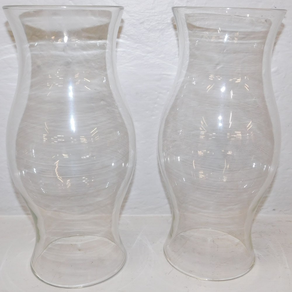 Two Glass Hurricane Shades: Two Glass Hurricane Shades . 13 1/2" H 5 1/2" Dia. ALL DESCRIPTIONS AND ANY CONDITION STATEMENT GIVEN BY LANGSTON AUCTION GALLERY ARE STRICTLY OPINIONS AND LANGSTON'S SHALL HAVE NO RESPONSIBILITY