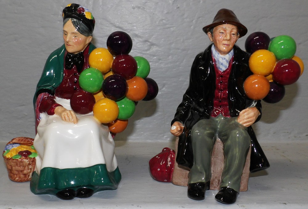Two Royal Doulton Balloon Man & Lady Figurines: Two Royal Doulton Balloon Man & Lady Figurines. 7 1/2" H 6 1/4" W ALL DESCRIPTIONS AND ANY CONDITION STATEMENT GIVEN BY LANGSTON AUCTION GALLERY ARE STRICTLY OPINIONS AND LANGSTON'S SHALL HAVE NO RESP
