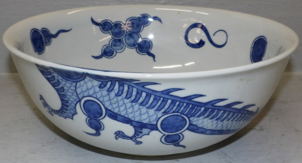 Oriental Porcelain Bowl 'Blue Dragon' Labeled Andrea by Sadek: Oriental Porcelain Bowl 'Blue Dragon' Labeled Andrea by Sadek. 5" H 12 1/2" Dia. ALL DESCRIPTIONS AND ANY CONDITION STATEMENT GIVEN BY LANGSTON AUCTION GALLERY ARE STRICTLY OPINIONS AND LANGSTON'S