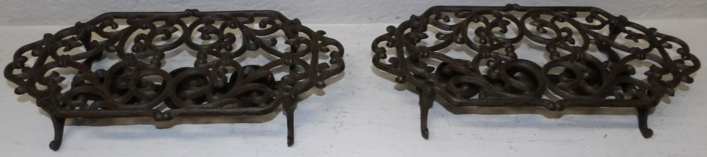 Pair of Cast Iron Warming Stands: Pair of Cast Iron Warming Stands . 2 1/2" H 13 3/4" W 6 3/4" D ALL DESCRIPTIONS AND ANY CONDITION STATEMENT GIVEN BY LANGSTON AUCTION GALLERY ARE STRICTLY OPINIONS AND LANGSTON'S SHALL HAVE NO