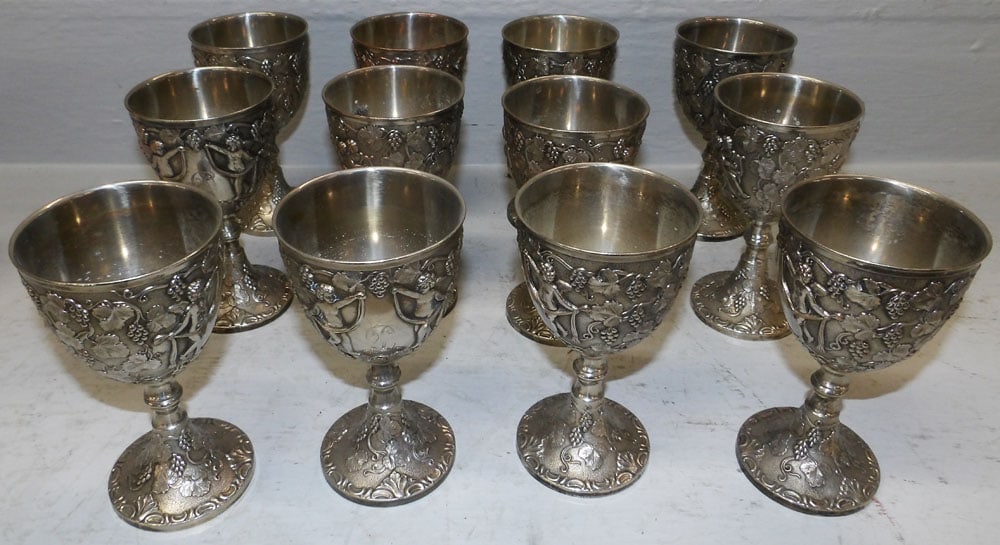 Twelve Silverplated Grape, Cable, & Cupid Goblets by Corbell & Co.: Twelve Silverplated Grape, Cable, & Cupid Goblets by Corbell & Co.. 5 3/4" H 3 1/4" Dia. ALL DESCRIPTIONS AND ANY CONDITION STATEMENT GIVEN BY LANGSTON AUCTION GALLERY ARE STRICTLY OPINIONS AND LANGST