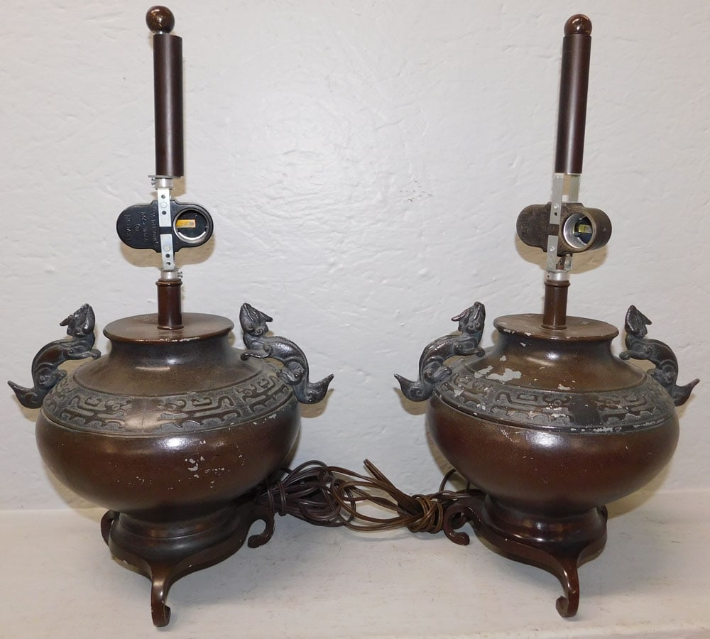 Pair of Painted Metal Oriental Urns Made Into Lamps with Foo Dog Handles: Pair of Painted Metal Oriental Urns Made Into Lamps with Foo Dog Handles . 18 3/4" H 10 1/2" W ALL DESCRIPTIONS AND ANY CONDITION STATEMENT GIVEN BY LANGSTON AUCTION GALLERY ARE STRICTLY OPINIONS