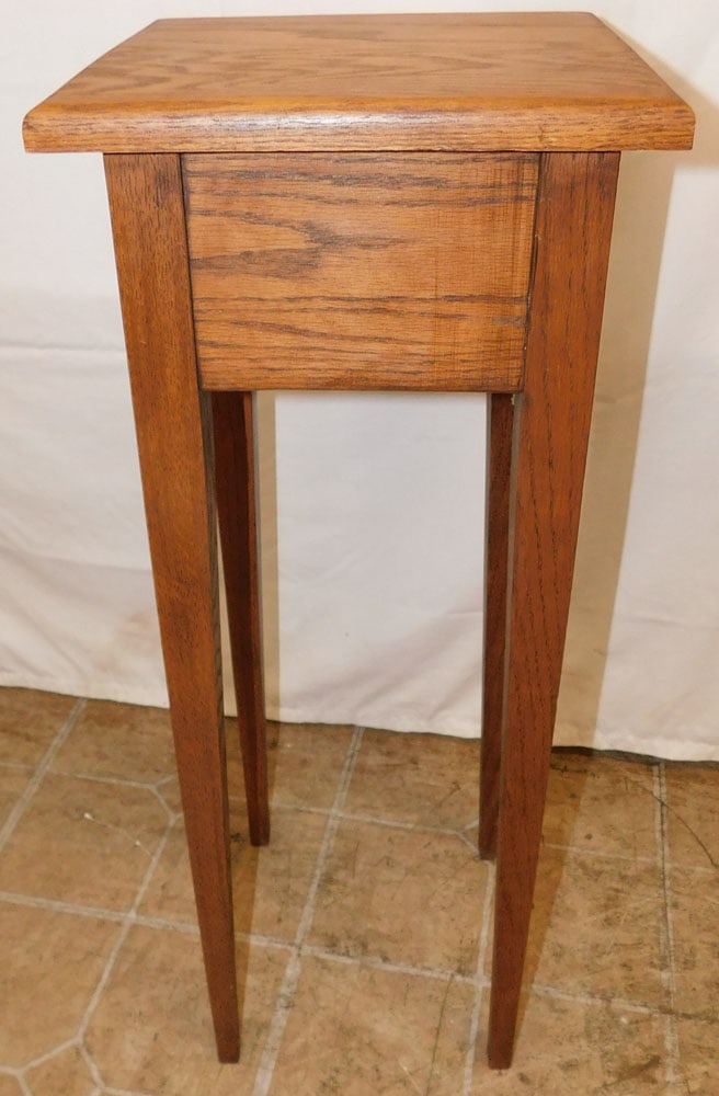 Oak Tapered Leg Plant Stand: Oak Tapered Leg Plant Stand . 28 1/4" H 11" Dia. ALL DESCRIPTIONS AND ANY CONDITION STATEMENT GIVEN BY LANGSTON AUCTION GALLERY ARE STRICTLY OPINIONS AND LANGSTON'S SHALL HAVE NO RESPONSIBILITY FOR ER
