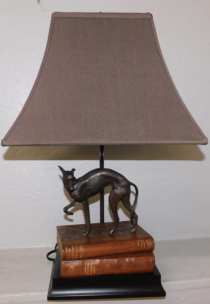 Bronze & Faux Resin Leather Books Whippet Lamp by Bombay: Bronze & Faux Resin Leather Books Whippet Lamp by Bombay. 21 1/4" H 14" W 9" D ALL DESCRIPTIONS AND ANY CONDITION STATEMENT GIVEN BY LANGSTON AUCTION GALLERY ARE STRICTLY OPINIONS AND LANGSTON'S
