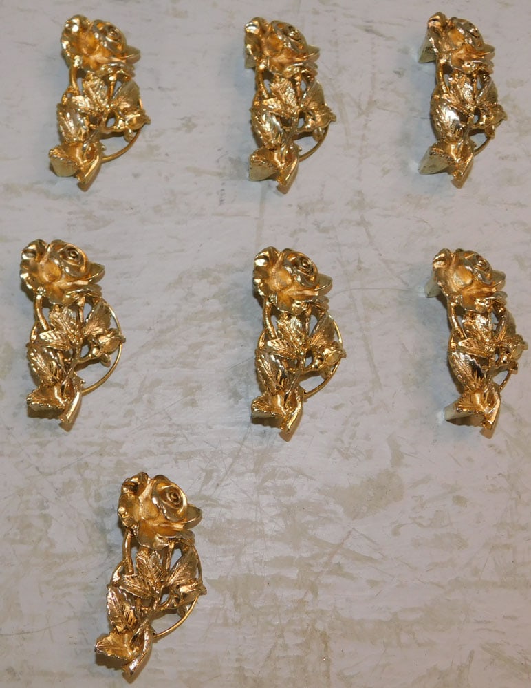 Seven Gilded Metal Floral Card Holders: Seven Gilded Metal Floral Card Holders. 1" H 2" W ALL DESCRIPTIONS AND ANY CONDITION STATEMENT GIVEN BY LANGSTON AUCTION GALLERY ARE STRICTLY OPINIONS AND LANGSTON'S SHALL HAVE NO RESPONSIBILITY FOR