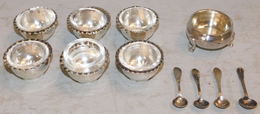 Seven Sterling Glass Lined Master Salts with Three Sterling Salt Spoons, (3.46 ozt.): Seven Sterling Glass Lined Master Salts with Three Sterling Salt Spoons, (3.46 ozt.). Up to 1" H 2" Dia. ALL DESCRIPTIONS AND ANY CONDITION STATEMENT GIVEN BY LANGSTON AUCTION GALLERY ARE STRICTLY