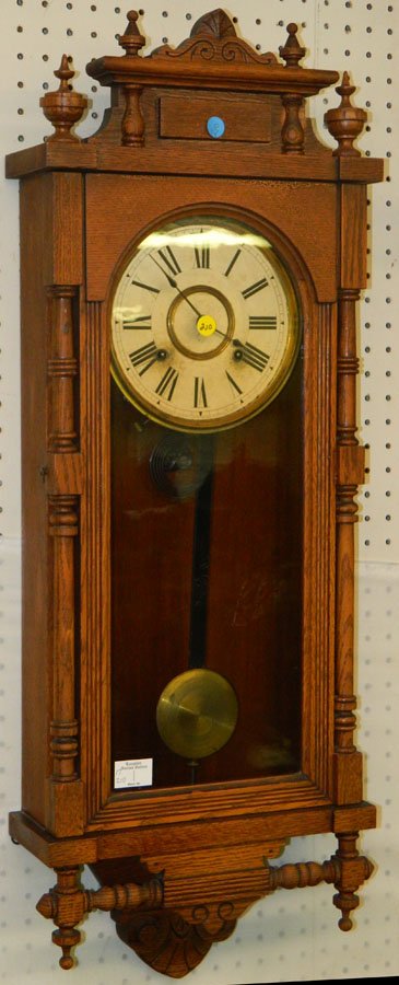 Victorian antique oak Ansonia wall clock.: Victorian antique oak Ansonia wall clock. 37" tall.