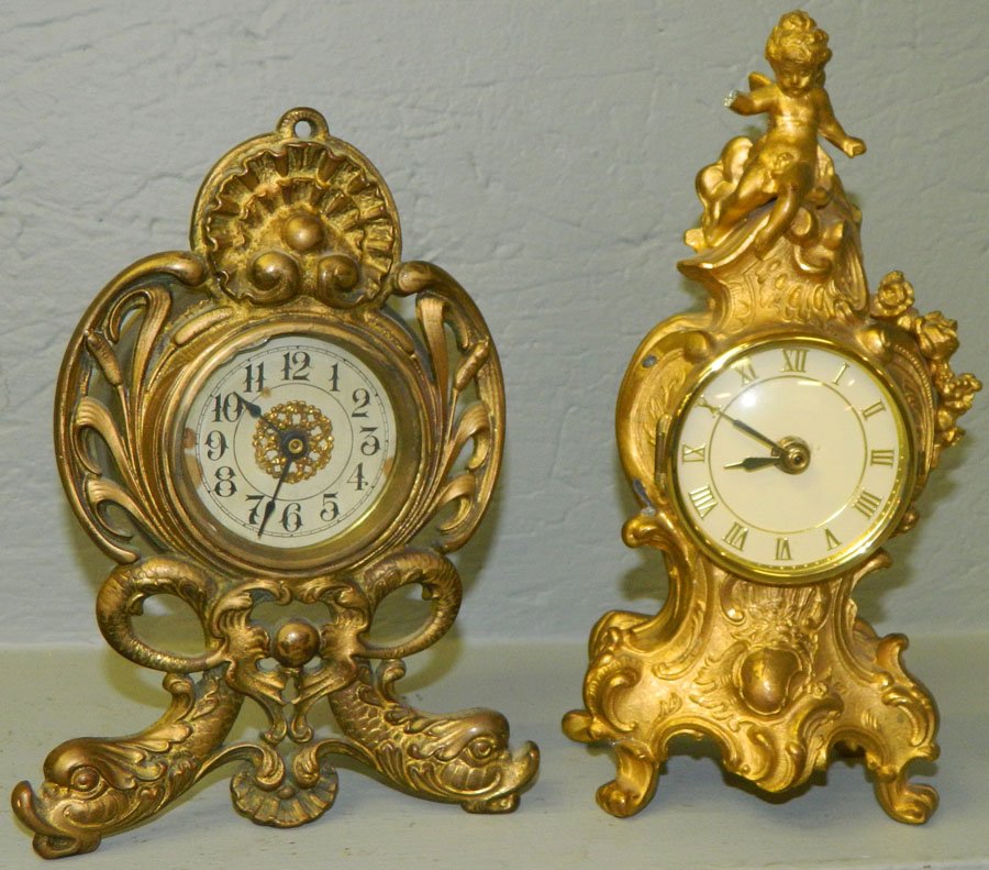 (2) Metal clocks. One key wind and one battery.: (2) Metal clocks. One key wind and one battery. 8 1/2" and 10" tall.