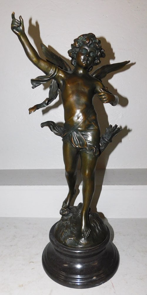 Bronze Cupid Statue on Marble Base: Bronze Cupid Statue on Marble Base . 28 1/4" H 11 3/4" W ALL DESCRIPTIONS AND ANY CONDITION STATEMENT GIVEN BY LANGSTON AUCTION GALLERY ARE STRICTLY OPINIONS AND LANGSTON'S SHALL HAVE NO RESPONSIBILIT