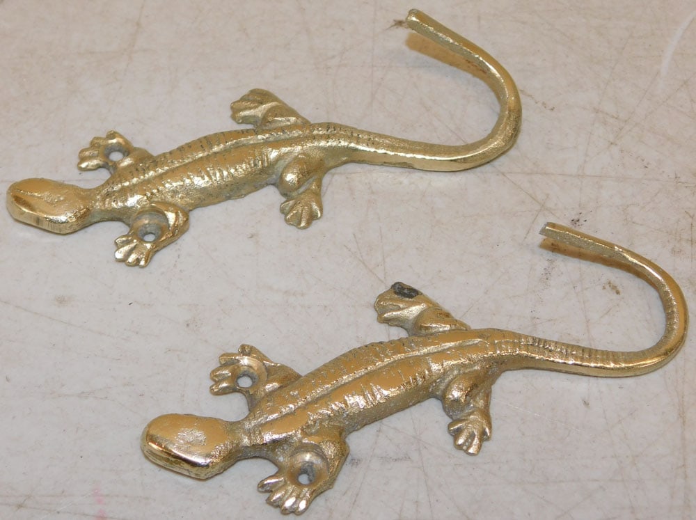 Two Cast Brass Lizard Form Wall Hooks: Two Cast Brass Lizard Form Wall Hooks. 4 1/2" L 1 3/4" W ALL DESCRIPTIONS AND ANY CONDITION STATEMENT GIVEN BY LANGSTON AUCTION GALLERY ARE STRICTLY OPINIONS AND LANGSTON'S SHALL HAVE NO