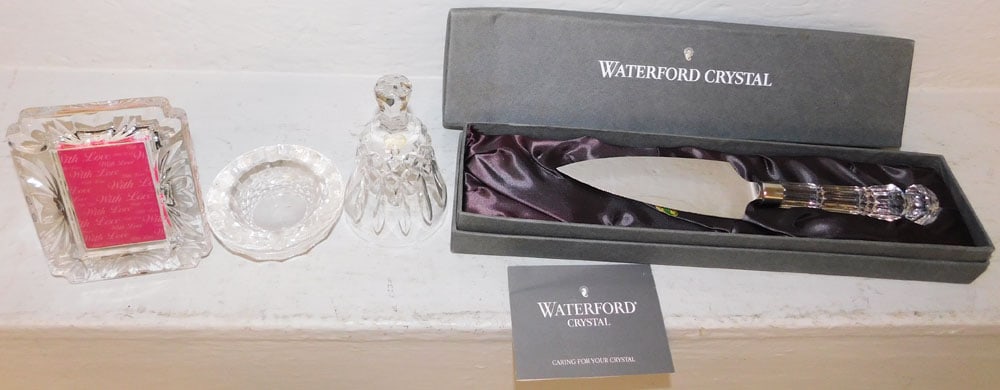 Four Pieces of Waterford Crystal & Cake Server in Box: Four Pieces of Waterford Crystal & Cake Server in Box . 14 3/4" W 3 3/4" D ALL DESCRIPTIONS AND ANY CONDITION STATEMENT GIVEN BY LANGSTON AUCTION GALLERY ARE STRICTLY OPINIONS AND LANGSTON'S SHALL HAV