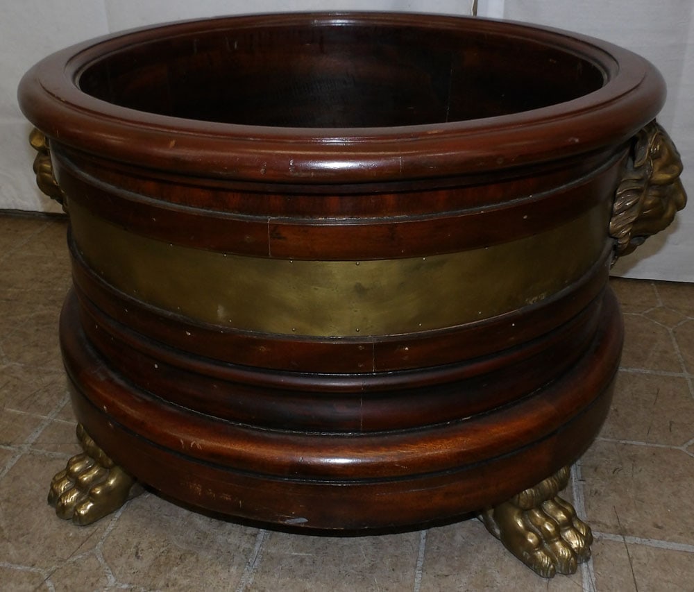 Mahogany & Brass Bound Wine Cooler with Lion Head Handles & Paw Feet by Maitland Smith: Mahogany & Brass Bound Wine Cooler with Lion Head Handles & Paw Feet by Maitland Smith . 16 1/2" H 28 3/4" W ALL DESCRIPTIONS AND ANY CONDITION STATEMENT GIVEN BY LANGSTON AUCTION GALLERY ARE STRICTLY