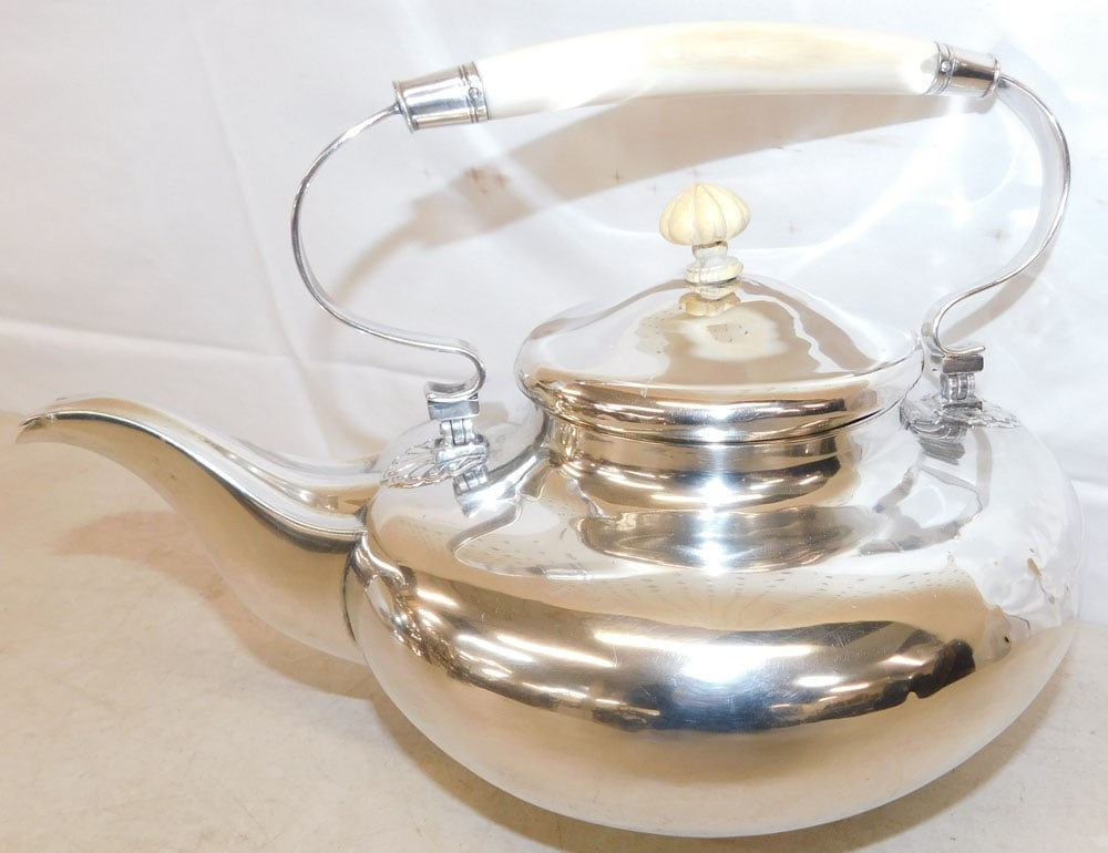 Silverplated Tea Pot with Bone Handle: Silverplated Tea Pot with Bone Handle . 6 3/4" H 11 1/4" W ALL DESCRIPTIONS AND ANY CONDITION STATEMENT GIVEN BY LANGSTON AUCTION GALLERY ARE STRICTLY OPINIONS AND LANGSTON'S SHALL HAVE NO