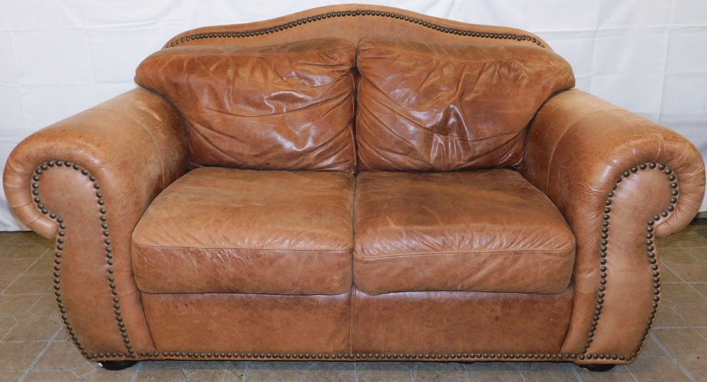 Leather Upholstered Loveseat by Robinson & Robinson Inc.: Leather Upholstered Loveseat by Robinson & Robinson Inc. . 38 1/4" H 67" W 38" D ALL DESCRIPTIONS AND ANY CONDITION STATEMENT GIVEN BY LANGSTON AUCTION GALLERY ARE STRICTLY OPINIONS AND LANGSTON'S