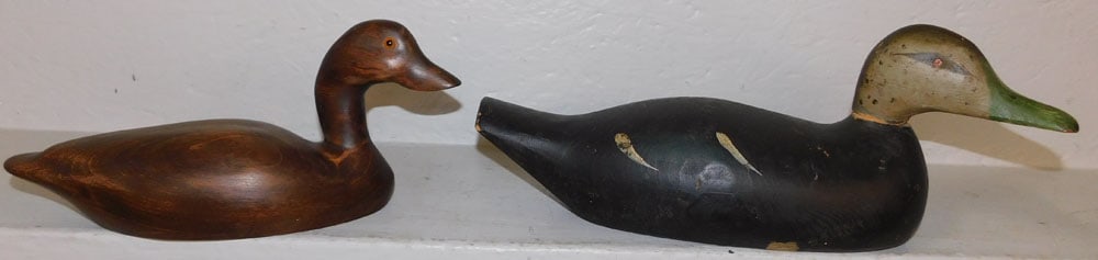 Two Carved Wood Duck Decoys, One Painted: Two Carved Wood Duck Decoys, One Painted . 6 3/4" H 17" W ALL DESCRIPTIONS AND ANY CONDITION STATEMENT GIVEN BY LANGSTON AUCTION GALLERY ARE STRICTLY OPINIONS AND LANGSTON'S SHALL HAVE NO