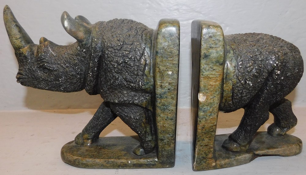 Carved Stone Rhino Book Ends: Carved Stone Rhino Book Ends . 7 1/2" H 13" W ALL DESCRIPTIONS AND ANY CONDITION STATEMENT GIVEN BY LANGSTON AUCTION GALLERY ARE STRICTLY OPINIONS AND LANGSTON'S SHALL HAVE NO RESPONSIBILITY FOR