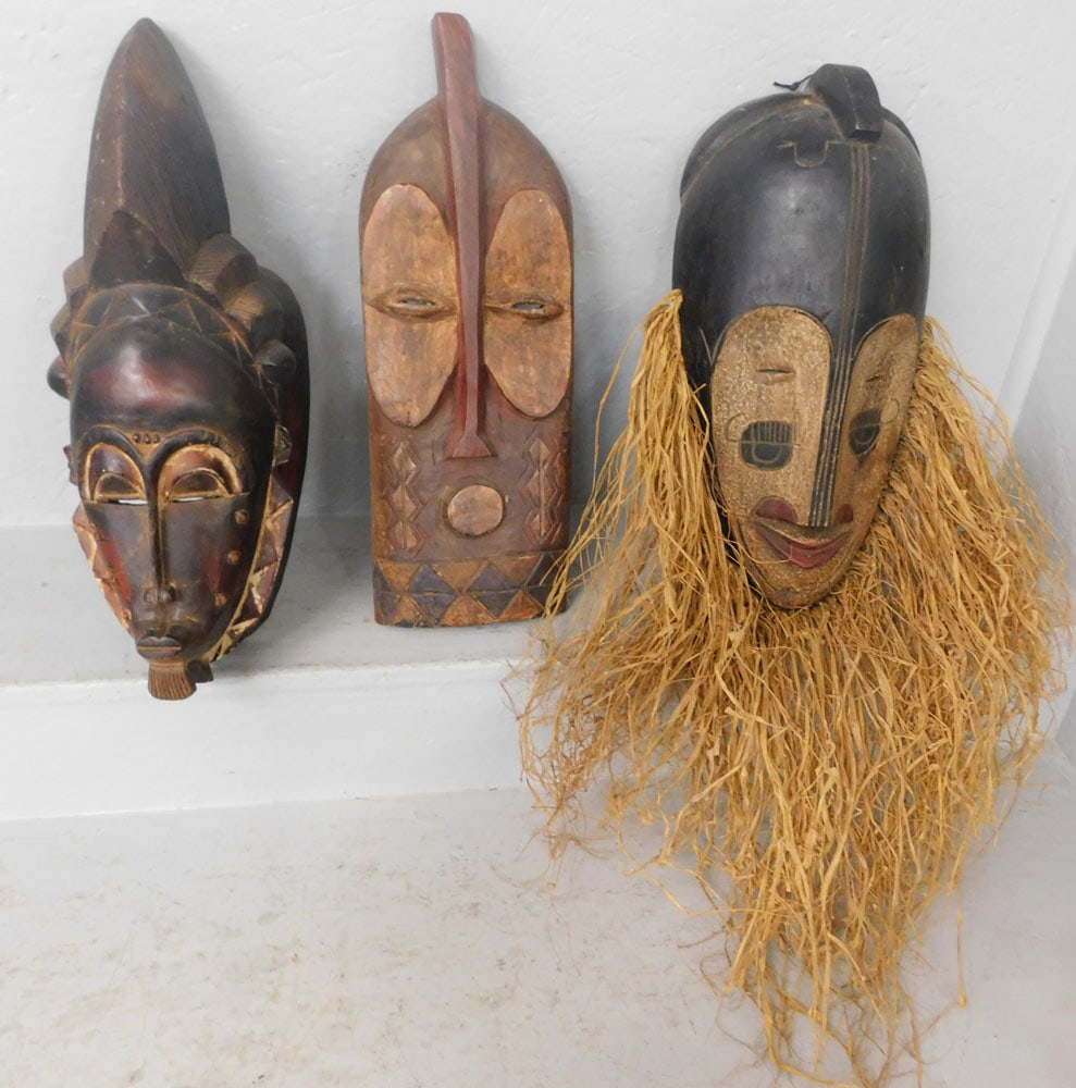 Three Carved Wood Masks: Three Carved Wood Masks. Up to 18 1/2" x 6 3/4" ALL DESCRIPTIONS AND ANY CONDITION STATEMENT GIVEN BY LANGSTON AUCTION GALLERY ARE STRICTLY OPINIONS AND LANGSTON'S SHALL HAVE NO RESPONSIBILITY FOR ERR
