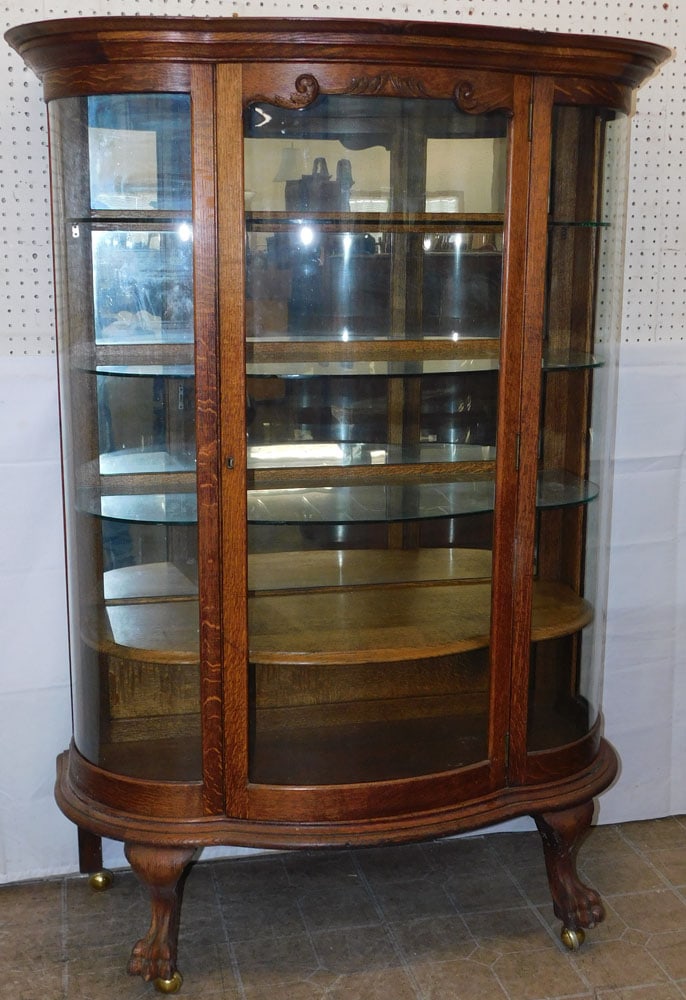 Antique Oak Bow Front China Cabinet with Mirror Back: Antique Oak Bow Front China Cabinet with Mirror Back . 64" H 46" W 20" D ALL DESCRIPTIONS AND ANY CONDITION STATEMENT GIVEN BY LANGSTON AUCTION GALLERY ARE STRICTLY OPINIONS AND LANGSTON'S SHALL HAVE
