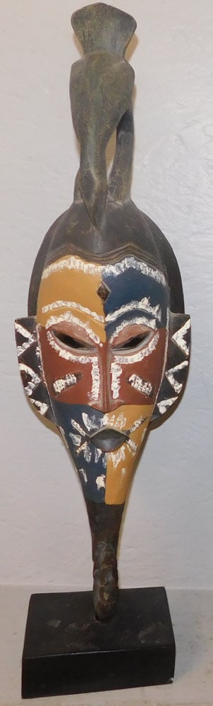 Carved Wood Mask on Stand: Carved Wood Mask on Stand . 26" H 7" W ALL DESCRIPTIONS AND ANY CONDITION STATEMENT GIVEN BY LANGSTON AUCTION GALLERY ARE STRICTLY OPINIONS AND LANGSTON'S SHALL HAVE NO RESPONSIBILITY FOR ERRORS OR OM